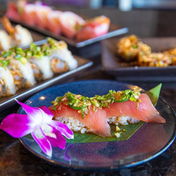 Blue Wasabi Sushi and Martini's tuna nigiri with jalapeño and cilantro, garnished with an orchid.